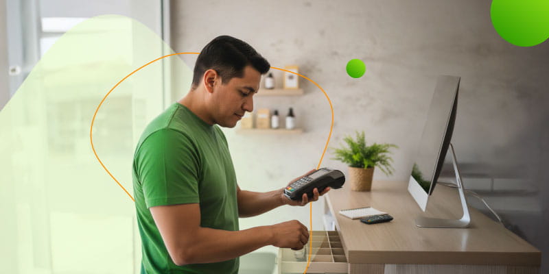 Emprendedor usando terminal móvil para cobrar pagos digitales en su negocio